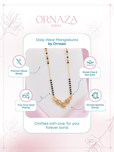 Ornaza Mangalsutra necklace on a pink cushion with brand details.